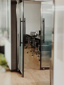 : Frosted vinyl etch film applied to a glass sidelight panel next to an office entrance door